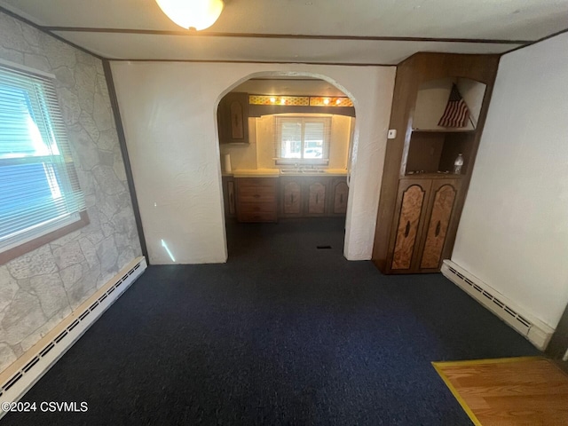 carpeted spare room with a baseboard radiator