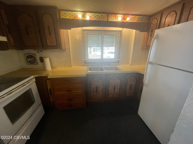 kitchen featuring white appliances and sink