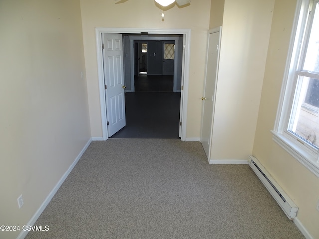 hall with carpet flooring and baseboard heating