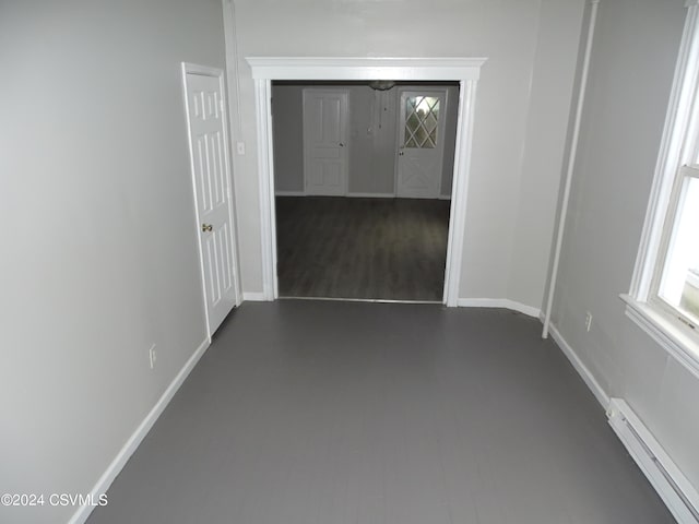 310 W 3rd St, Mount Carmel, PA 17851 - spare room featuring dark wood-style flooring, baseboards, and a baseboard heating unit