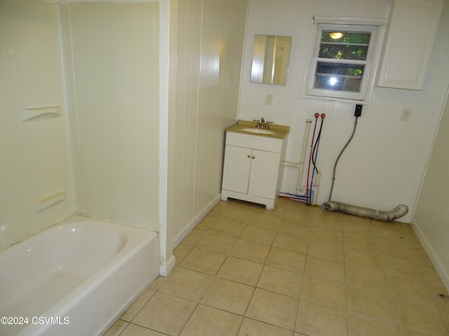 bathroom featuring vanity, tile patterned floors, and a washtub