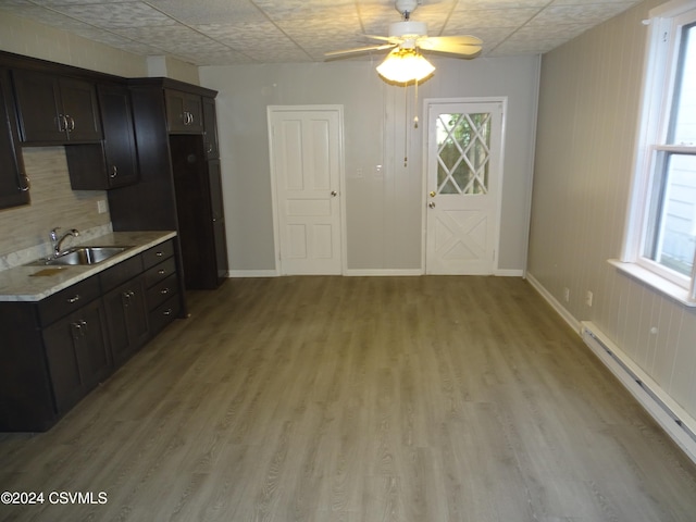 kitchen featuring sink, a baseboard heating unit, ceiling fan, dark brown cabinetry, and light hardwood / wood-style flooring