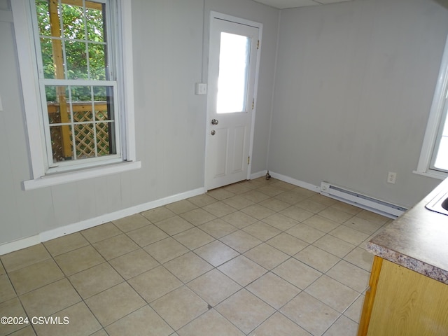 310 W 3rd St, Mount Carmel, PA 17851 - foyer featuring light tile patterned floors, baseboards, a baseboard heating unit, and a wealth of natural light
