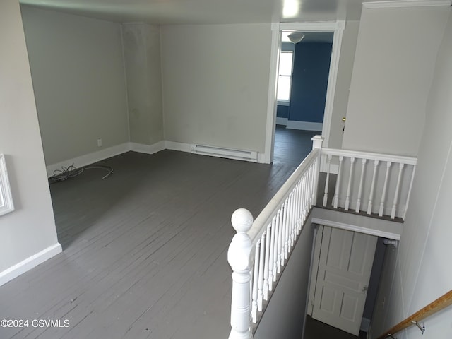 empty room featuring a baseboard radiator and hardwood / wood-style floors