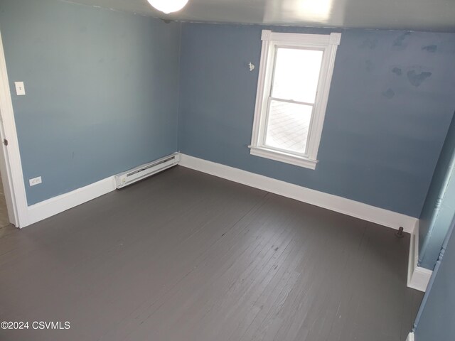 310 W 3rd St, Mount Carmel, PA 17851 - unfurnished room with baseboards, dark wood finished floors, and a baseboard radiator