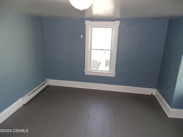 spare room with a baseboard radiator and hardwood / wood-style floors