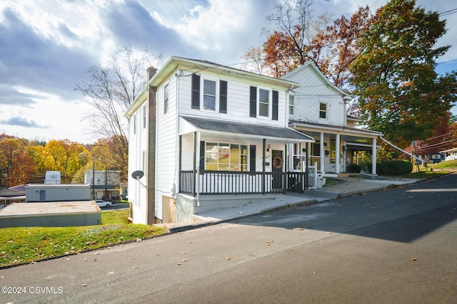 1766 W Chestnut St, Coal Township, PA 17866 - view of front of house with covered porch and a chimney
