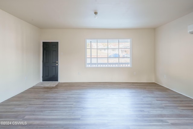 1766 W Chestnut St, Coal Township, PA 17866 - spare room featuring wood finished floors and a wall mounted air conditioner