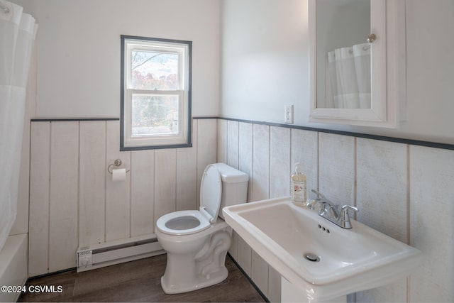 full bathroom featuring hardwood / wood-style flooring, toilet, shower / bath combo, baseboard heating, and sink