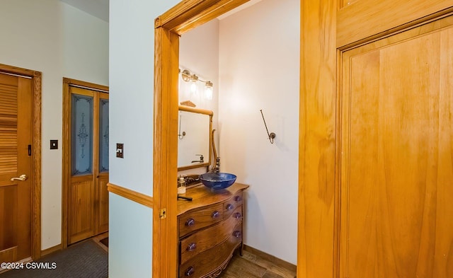 hallway with sink and dark wood-type flooring