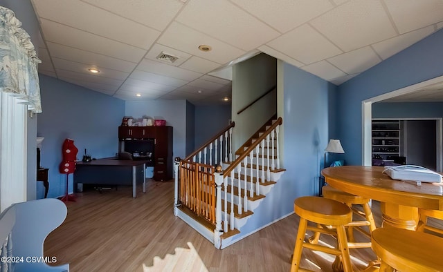 stairway featuring hardwood / wood-style floors and a drop ceiling