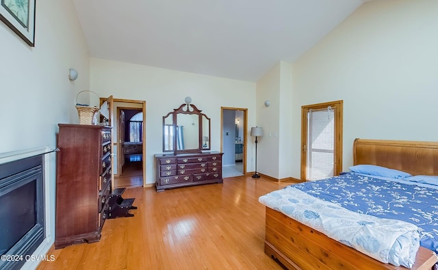 bedroom featuring wood-type flooring and vaulted ceiling