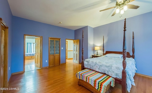 bedroom featuring ensuite bath, light hardwood / wood-style floors, and ceiling fan