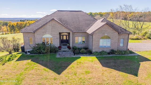 view of front of property featuring central AC and a front lawn