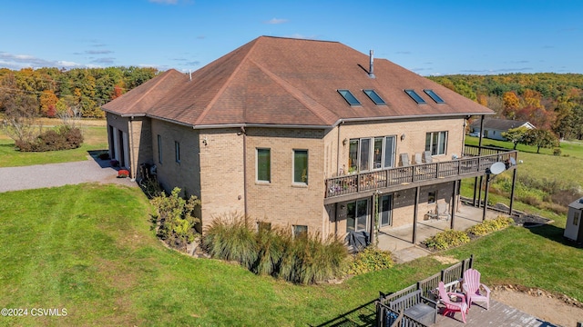 back of house with a yard and a patio