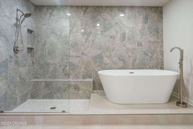 bathroom with tile walls and independent shower and bath