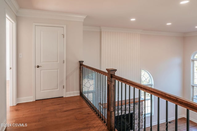 hallway featuring recessed lighting, baseboards, an upstairs landing, wood finished floors, and ornamental molding