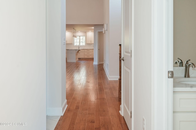 hall featuring sink and light wood-type flooring