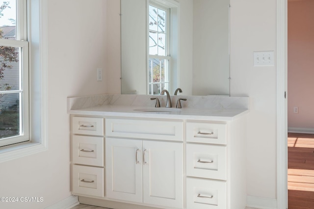 bathroom with vanity and baseboards