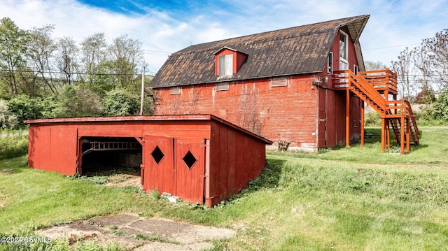 view of outbuilding featuring a lawn