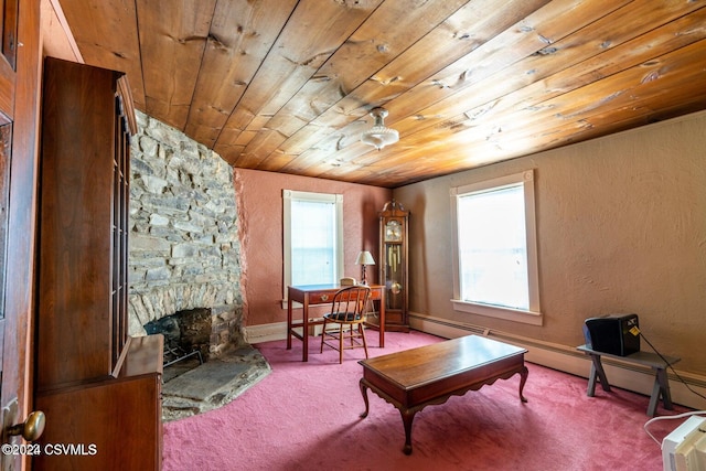 living area with a stone fireplace, wood ceiling, carpet flooring, and plenty of natural light