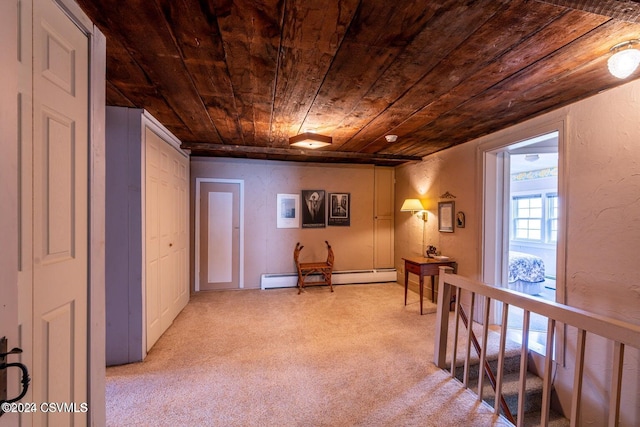 corridor with wood ceiling, baseboard heating, and light colored carpet