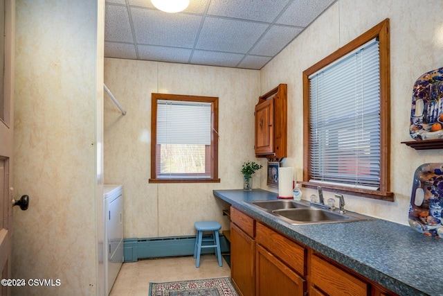 kitchen with a drop ceiling, washer / clothes dryer, baseboard heating, and sink