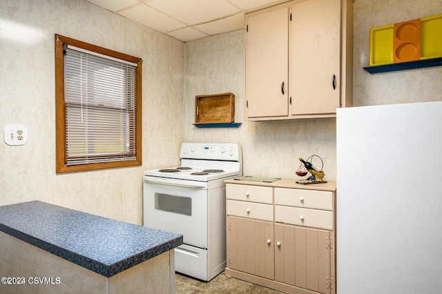 kitchen with a paneled ceiling and electric range