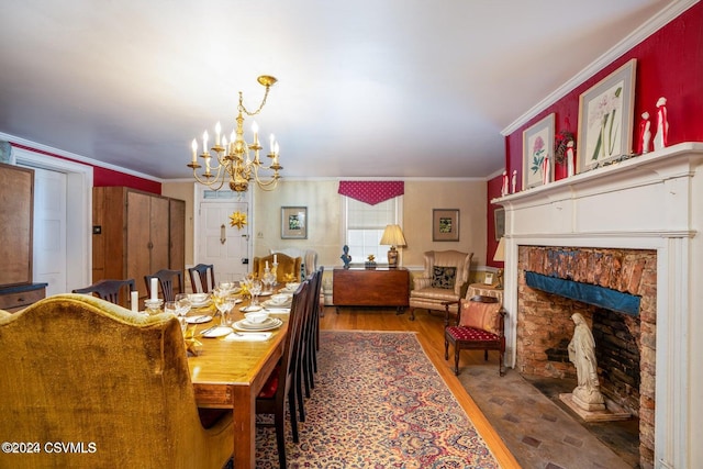 dining area with crown molding, a chandelier, and wood-type flooring