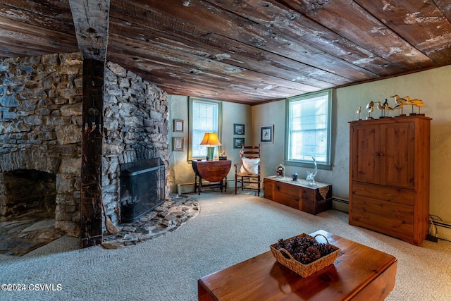 living room featuring a stone fireplace, wood ceiling, baseboard heating, and carpet flooring