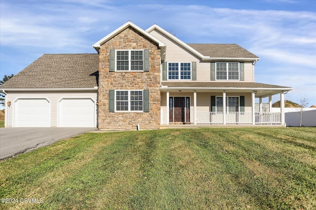 view of front of property with a garage, a porch, and a front lawn