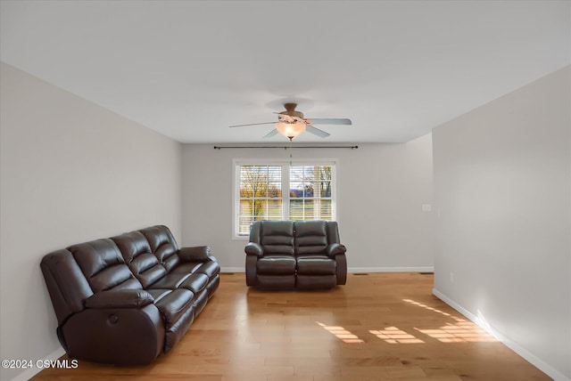 living room with ceiling fan and light wood-type flooring