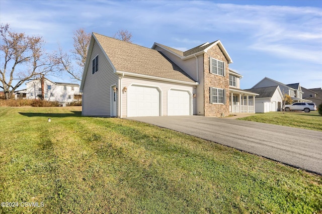 view of front of house featuring a front yard and a garage