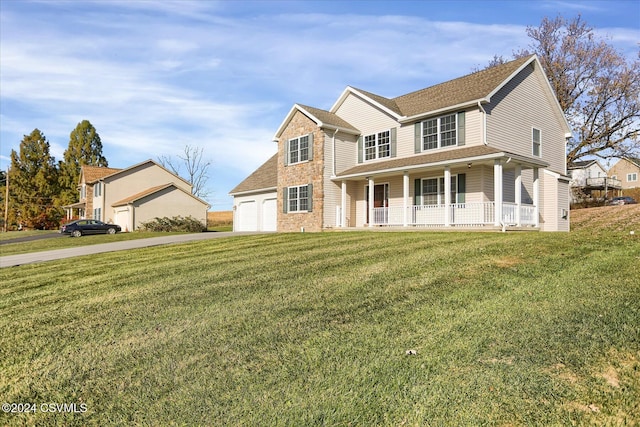 view of front of home featuring a porch, a front lawn, and a garage