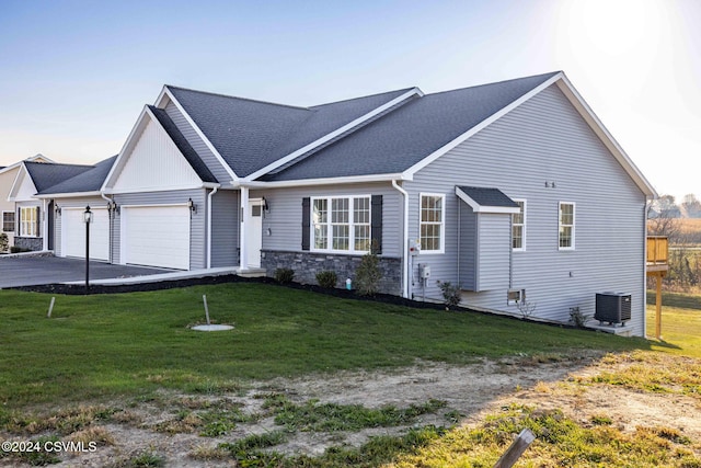 view of front facade featuring central AC, a garage, and a front lawn