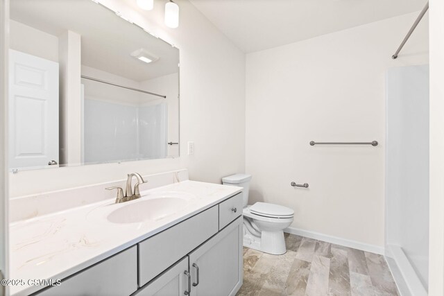 bathroom with vanity, wood-type flooring, walk in shower, and toilet