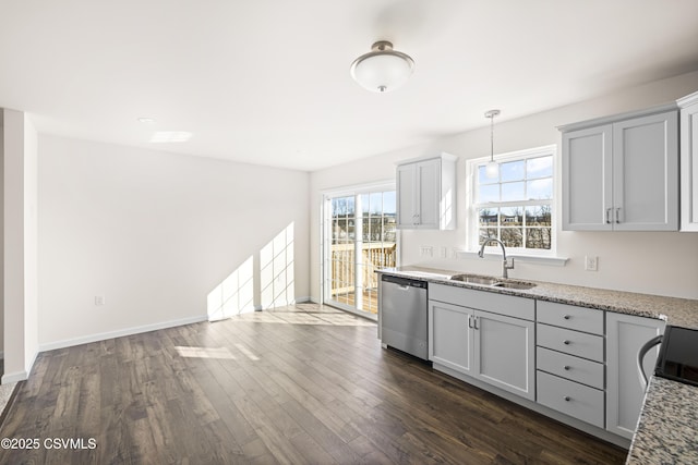 kitchen featuring sink, light stone counters, dark hardwood / wood-style flooring, dishwasher, and pendant lighting