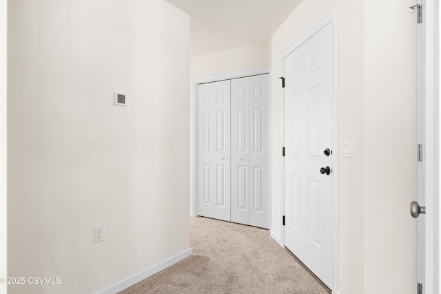 hall featuring light colored carpet