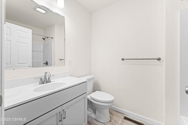 bathroom featuring vanity, tile patterned floors, toilet, and walk in shower