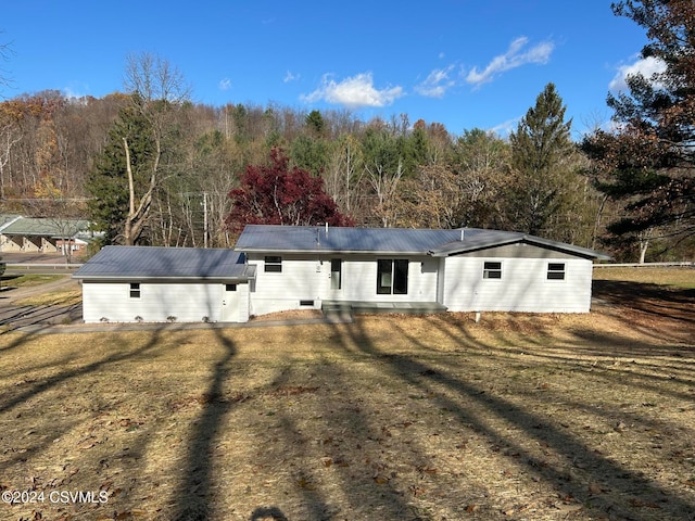 rear view of property with a yard