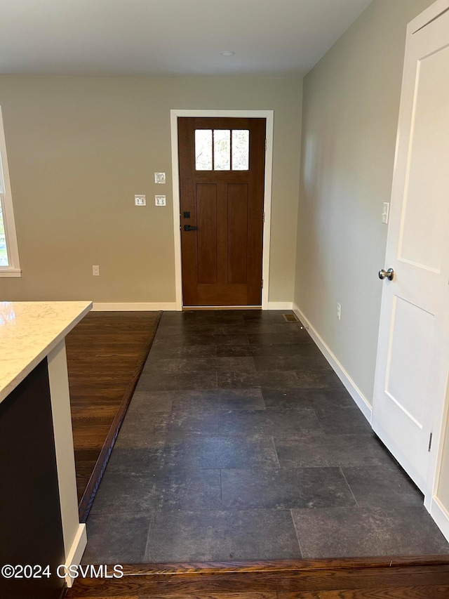 foyer entrance with dark hardwood / wood-style floors