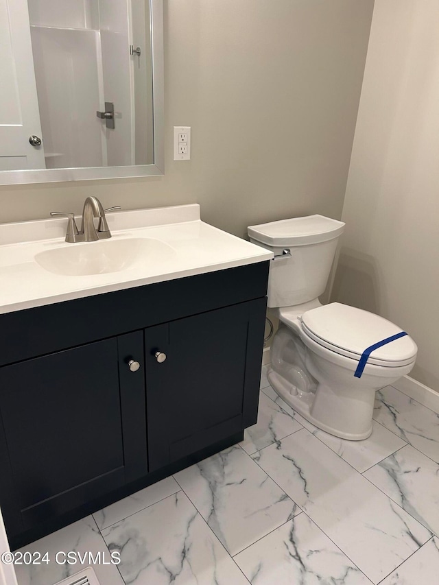 bathroom with vanity and toilet