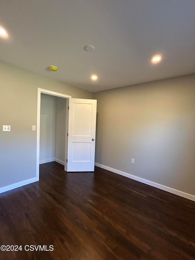 spare room featuring dark wood-type flooring