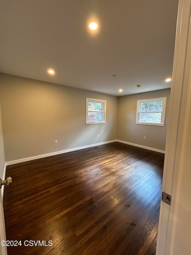 spare room featuring dark wood-type flooring