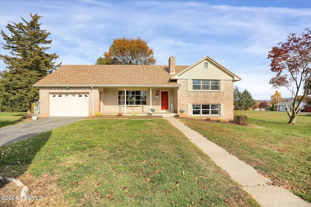 view of front of home with a front yard and a garage