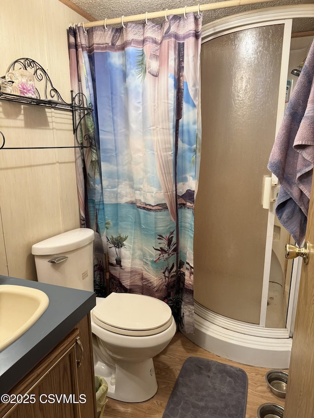 bathroom with toilet, vanity, a shower with shower curtain, and a textured ceiling