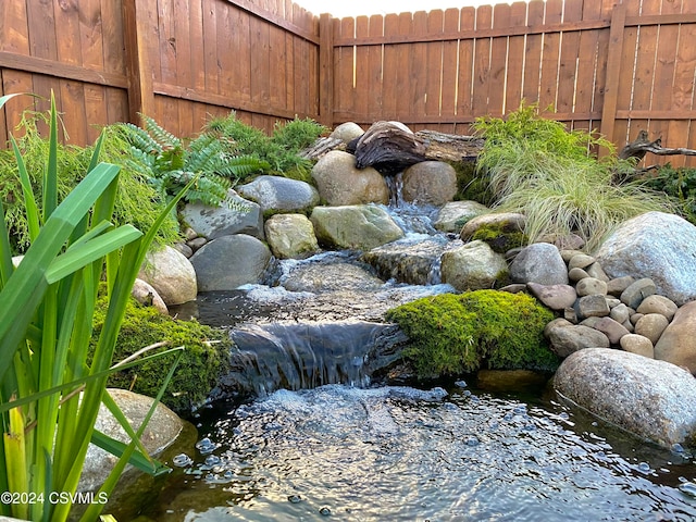 view of yard with a small pond