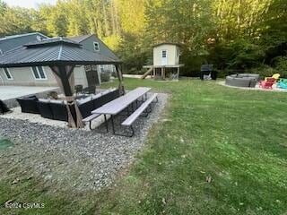 view of community with a patio area, a gazebo, and a lawn