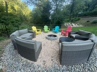 view of patio with an outdoor living space with a fire pit