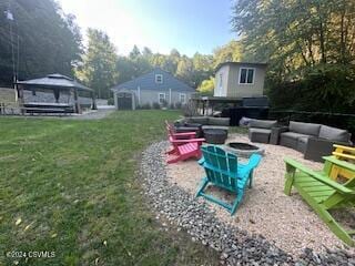 view of yard with a patio and an outdoor living space with a fire pit